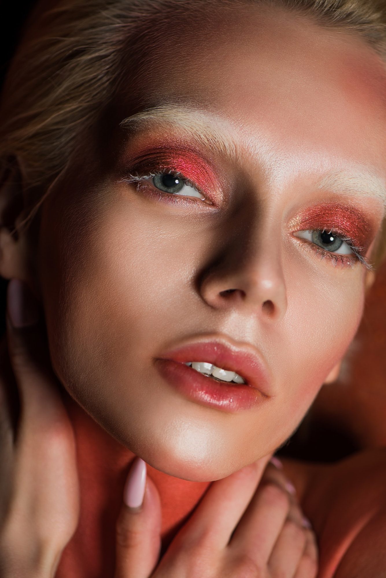sensual woman with red makeup looking at camera