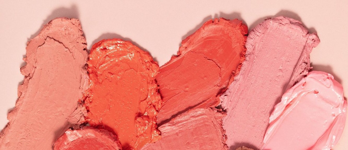 Various lipstick smudged. Mat lipstick texture background